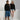 Kinder-Hoodie PLAYER ONE schwarz, Vorderseite mit goldenem Pixelherz und P1 auf der Brust – powered by Nyrra-Design
